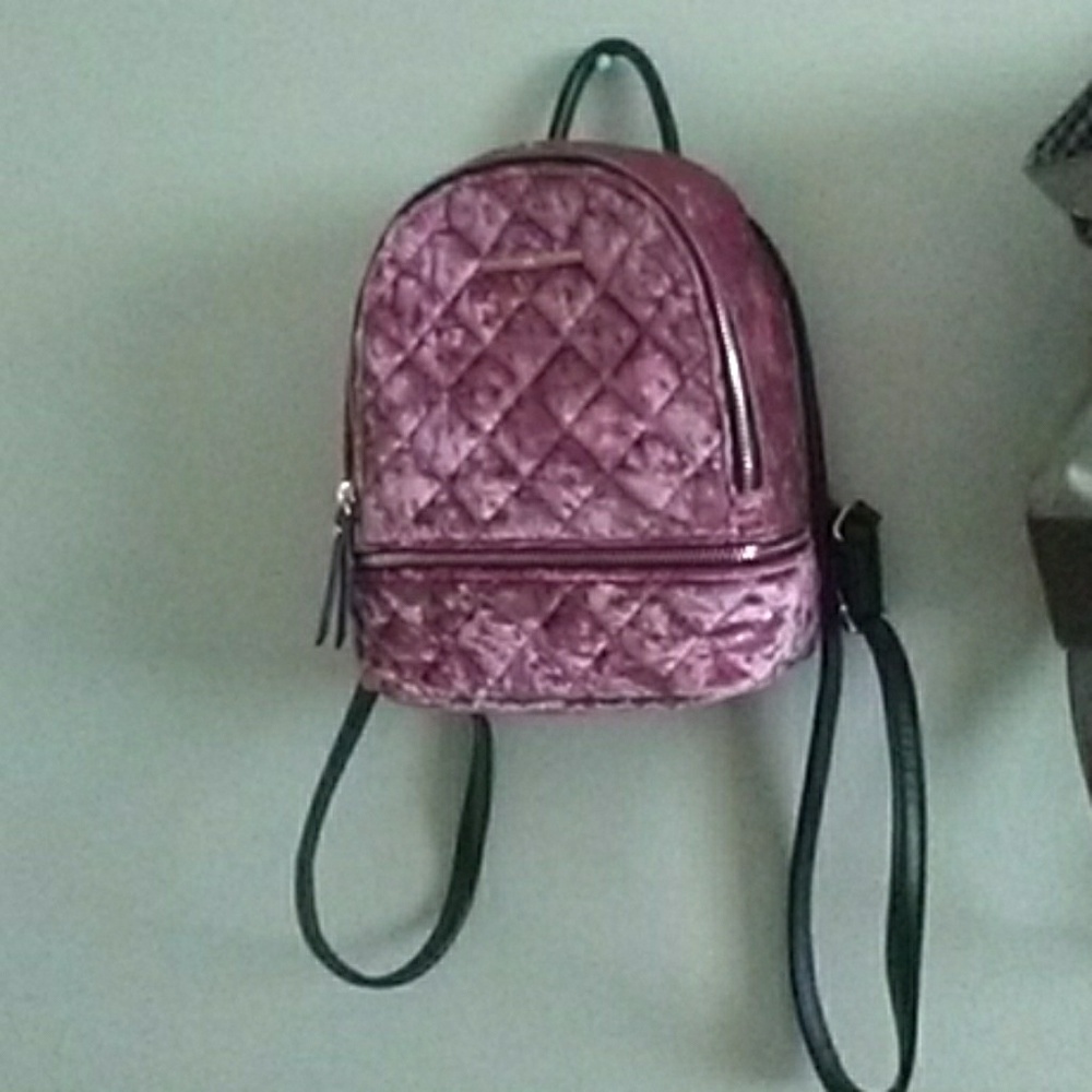 A pink Aldo backpack purse